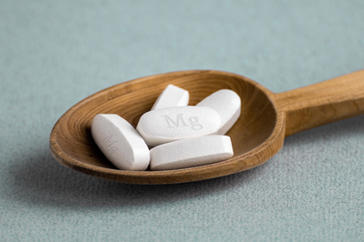 magnesium pills laid out on a wooden spoon