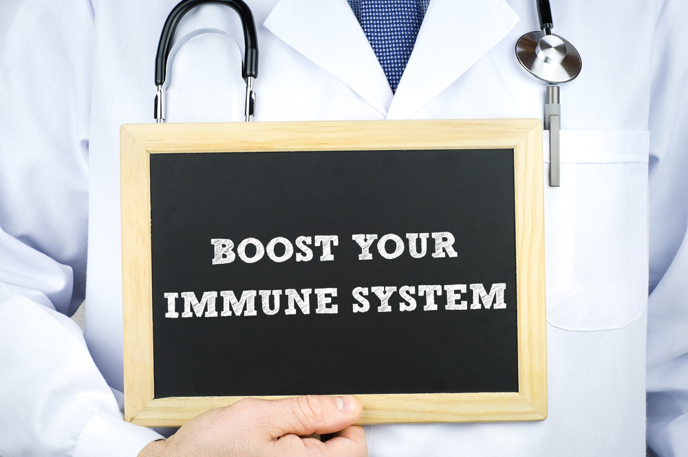 doctor holding a sign that says boost your immune system