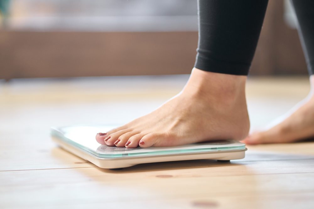 woman's foot stepping on scale